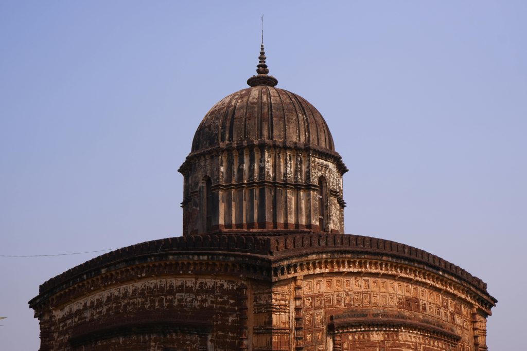 Monumental dome of the Radha Shyam Temple under a clear blue sky, symbolizing Indian spirituality.